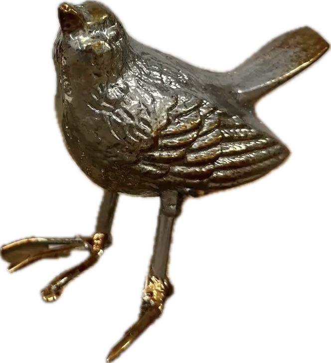 Metallic bird figurine on a white background