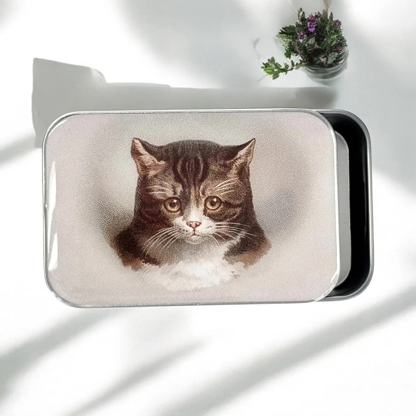 Rectangular pouch with a cat illustration on a white surface