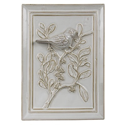 Decorative wall tile with a bird and branch design on a white background