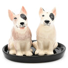 Two ceramic dog figurines on a black tray with a white background