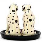 Two ceramic Dalmatian dog salt and pepper shakers on a black base.