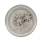 Decorative round panel with floral design on a white background
