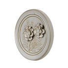 Decorative wall plate with floral design on a white background