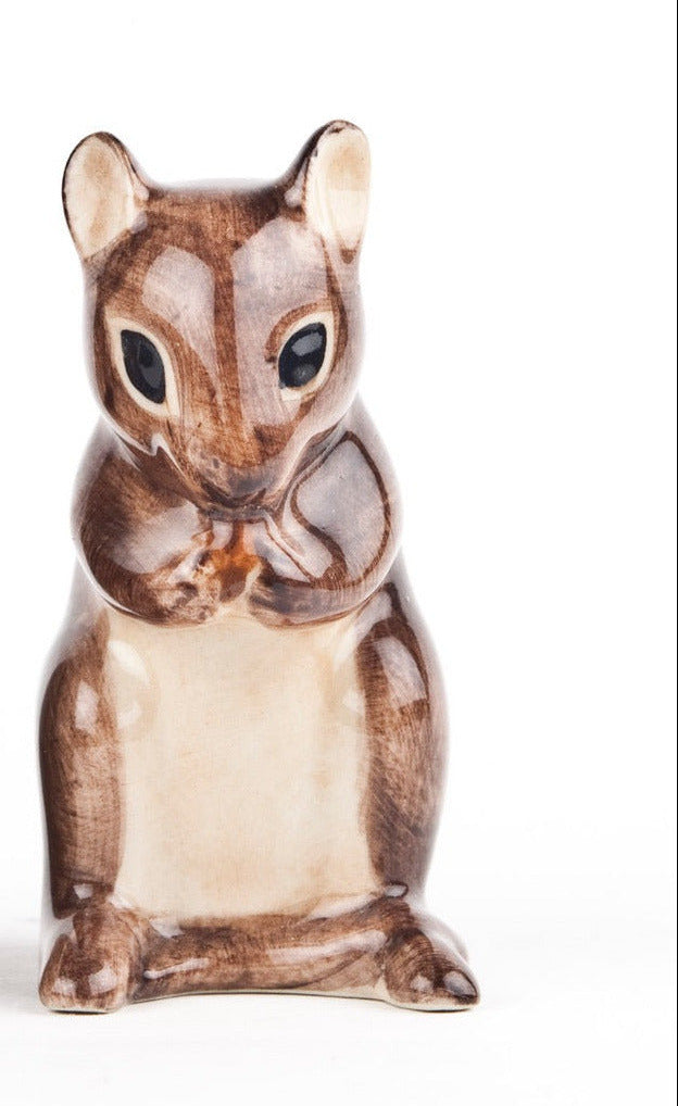 Two ceramic squirrel figurines on a white background