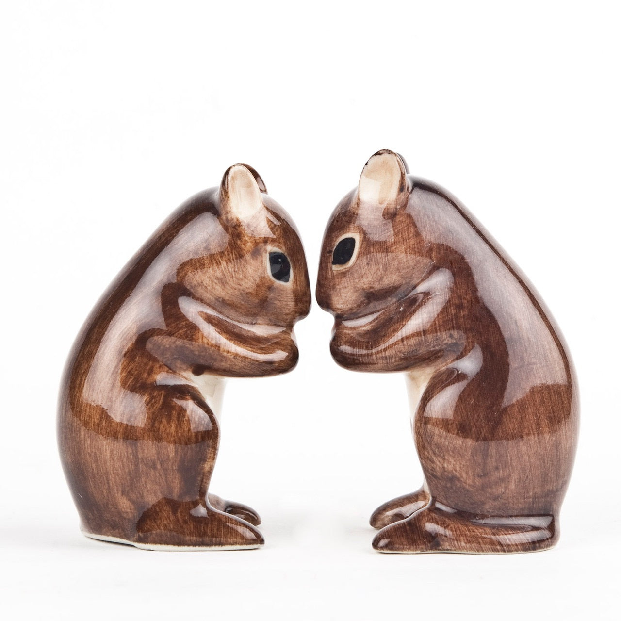 Wooden squirrel figurines on a white background