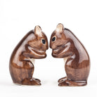Wooden squirrel figurines on a white background