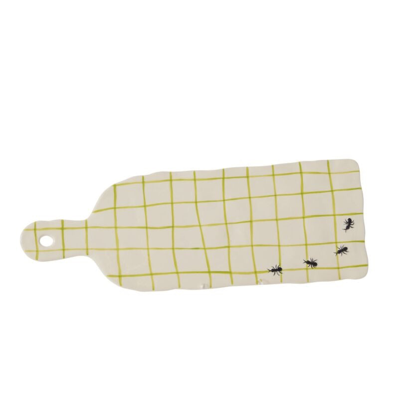 Rectangular cutting board with yellow grid pattern and black ants on a white background
