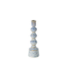 A tall, multi-tiered ceramic candlestick holder with a textured blue and white speckled glaze and subtle gold accents, set against a plain white background.