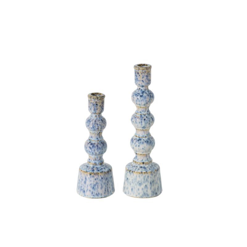 Two blue speckled ceramic candle holders on a white background