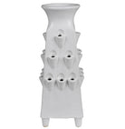 A white ceramic planter with a tiered design, featuring multiple small cup-like openings on the front that release water, set against a plain white background.