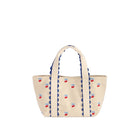Beige tote bag with blue scalloped edge and red cherry designs on a white background