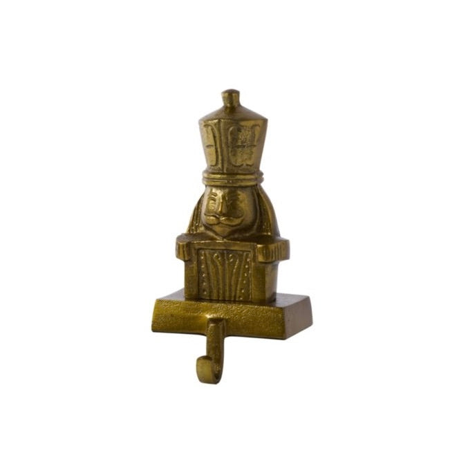 A small decorative nutcracker-shaped wall hook in a metallic antique gold/bronze finish, shown against a plain white background.