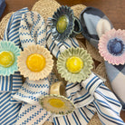 Napkin rings with floral designs on striped napkins