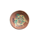Ceramic bowl with decorative design on a white background