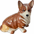 Ceramic figurine of a brown and white dog on a white background