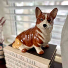 Dog figurine on a stack of books with a blurred background