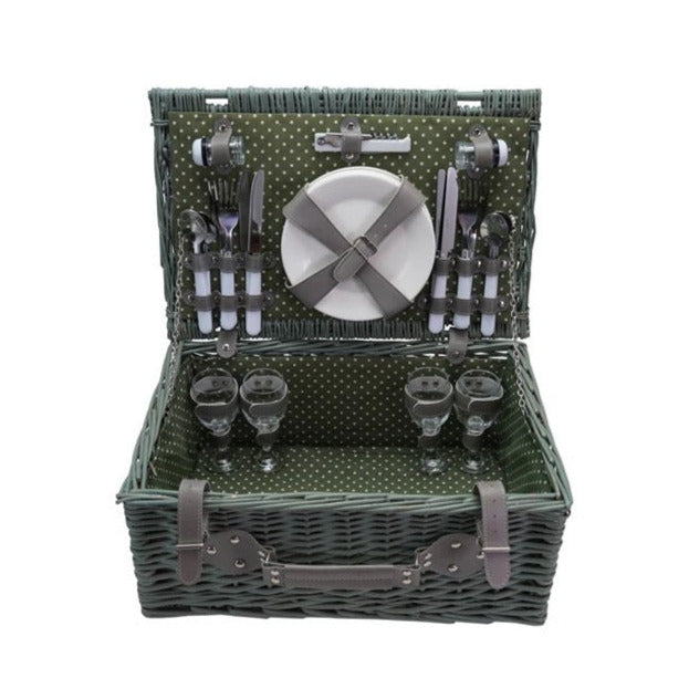 Green picnic basket with cutlery and plates on a white background
