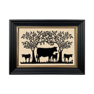 Framed artwork with black silhouettes of cows and trees on a beige background