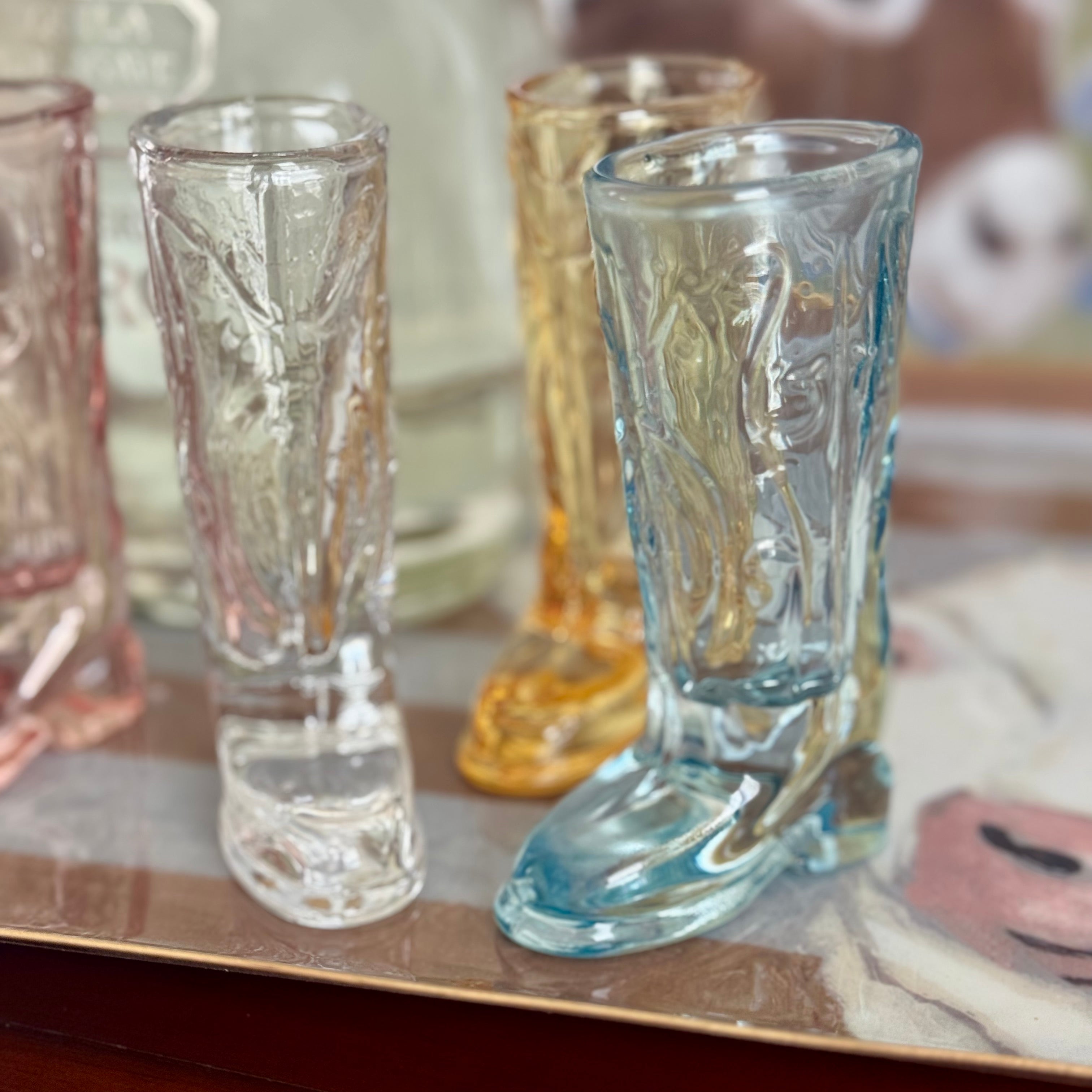 Set of patterned glass shot glasses on a reflective surface