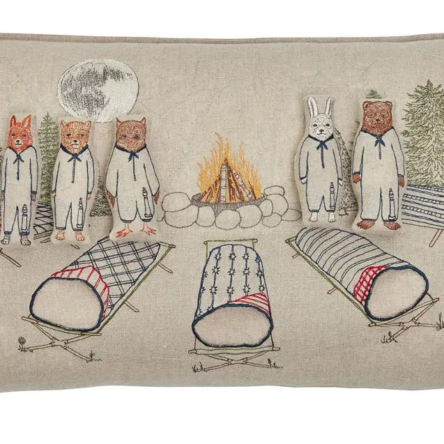 Embroidered design of animals around a campfire with tents and trees on a beige background.