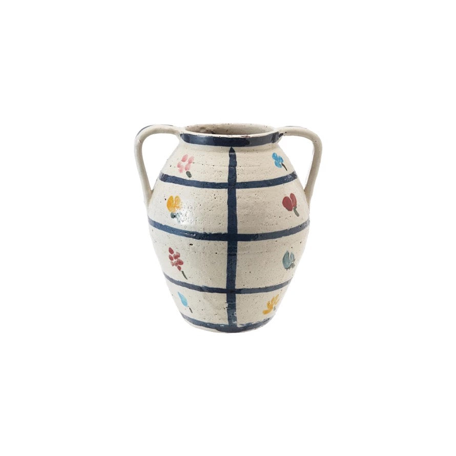Ceramic vase with floral patterns and grid design on a white background
