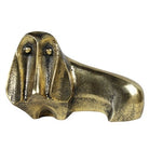 Brass dog-shaped object on a white background