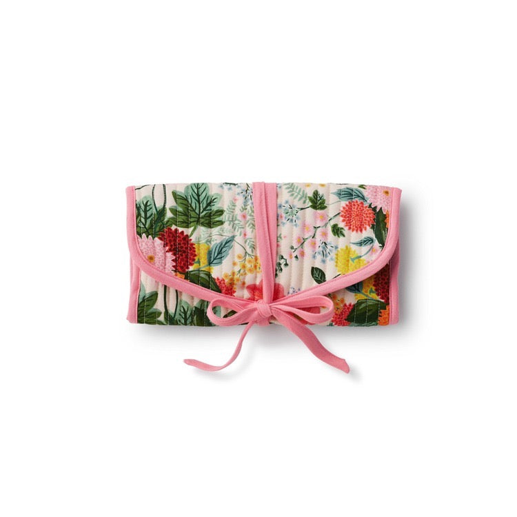 Floral-patterned clutch with a pink bow on a white background