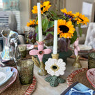 Decorative table setting with sunflowers, candles, and ornate candle holders.