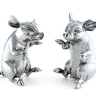 Two silver pig figurines on a white background