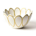 White ceramic bowl with gold leaf patterns on a white background
