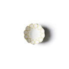 Decorative white bowl with gold geometric patterns on a white background