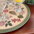 Floral-patterned glass coaster with a glass on a wooden surface