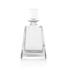 A clear crystal decanter with a rounded body and a bulbous mid-section, featuring a small protruding stopper.
