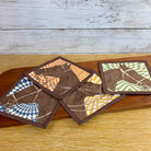 Set of patterned coasters on a wooden surface with a rustic background