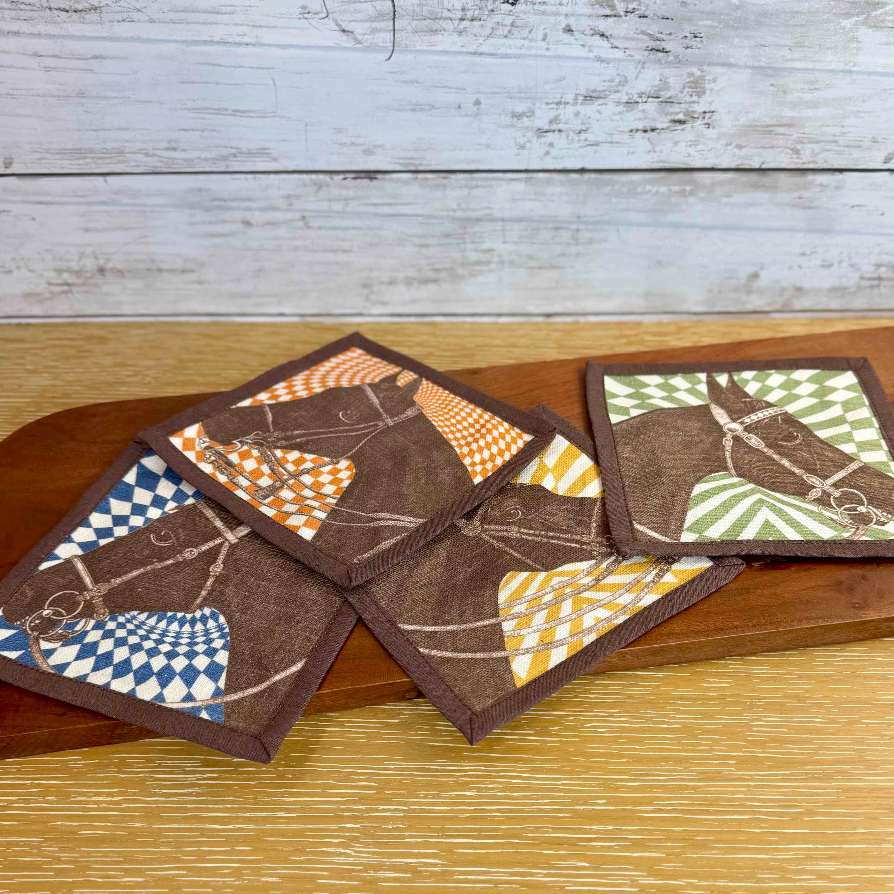 Set of patterned coasters on a wooden surface with a rustic background