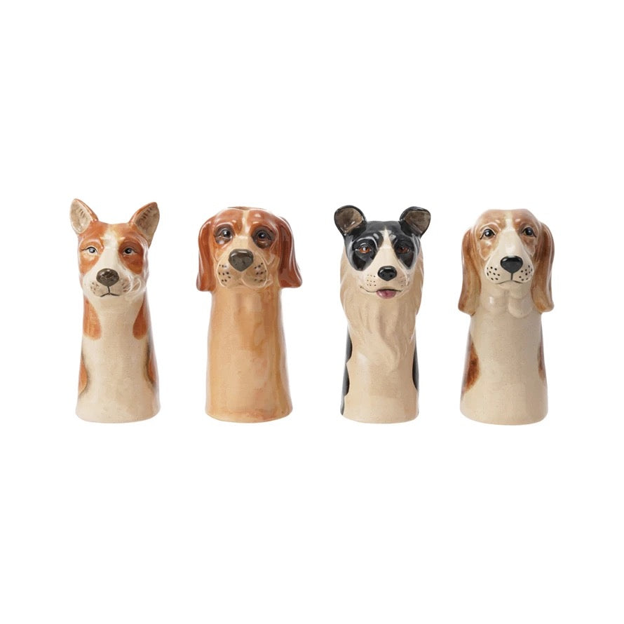 Set of four dog-shaped figurines on a white background