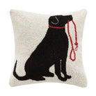 Decorative pillow with a black dog silhouette and red leash on a beige background