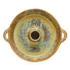 Round ceramic dish with handles on a white background