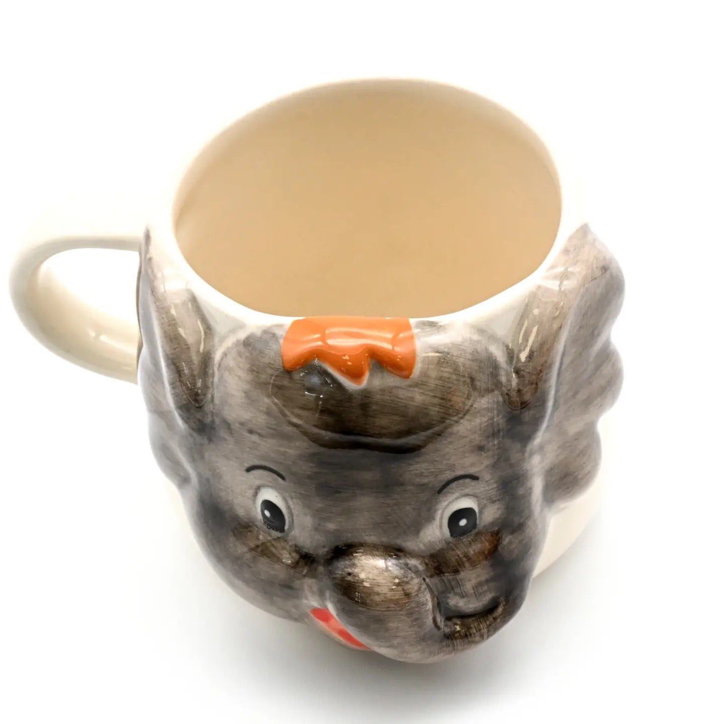 Cat-shaped mug with a carrot on a white background