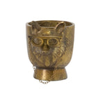 Bronze owl-shaped container with glasses on a white background