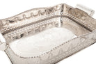 Silver decorative tray with intricate patterns on a white background