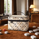 Plaid-patterned cosmetic bag on a table with dice and game pieces
