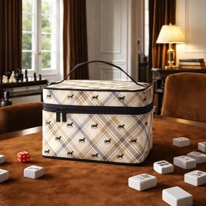 Plaid-patterned cosmetic bag on a table with dice and game pieces