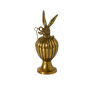 Decorative brass container with rabbit head design on a white background