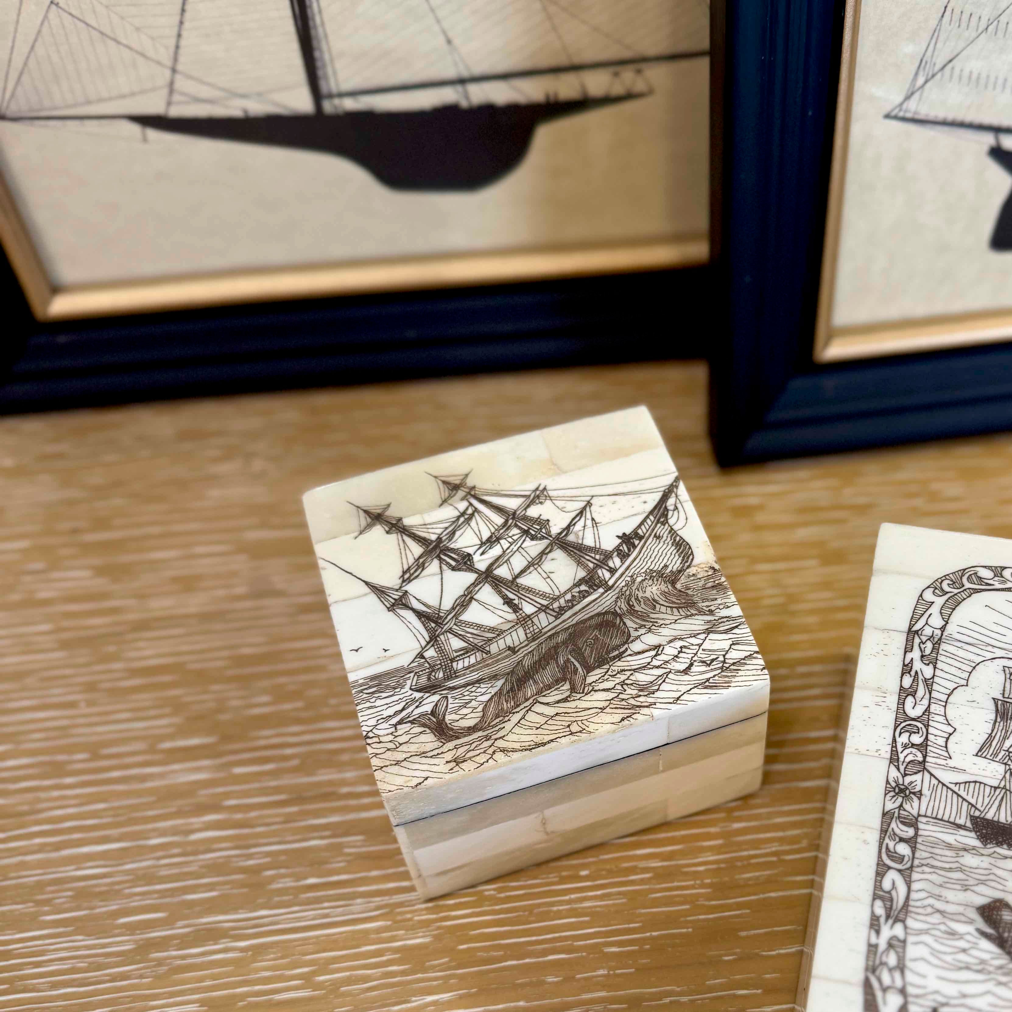 Wooden blocks with ship designs on a wooden surface