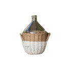 Wicker basket with a glass bottle inside on a white background