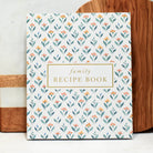 Family recipe book with floral pattern on a wooden surface