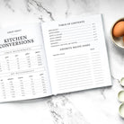 Open cookbook with table of contents on a marble surface