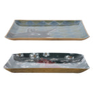 Two ceramic trays with artistic designs on a white background