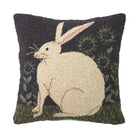 Decorative pillow with a white rabbit design on a dark background